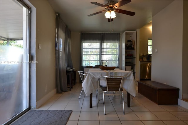 dining space featuring ceiling fan, plenty of natural light, baseboards, and light tile patterned floors