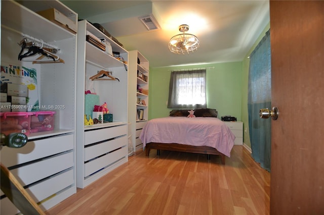 bedroom featuring visible vents and light wood-style floors