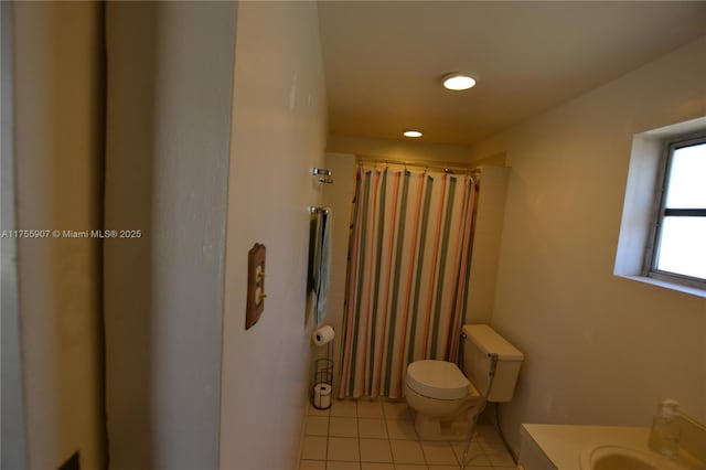 bathroom with toilet, a shower with curtain, and tile patterned flooring