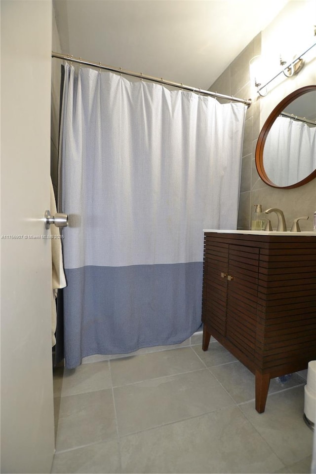 full bathroom featuring a shower with curtain, vanity, and tile patterned floors