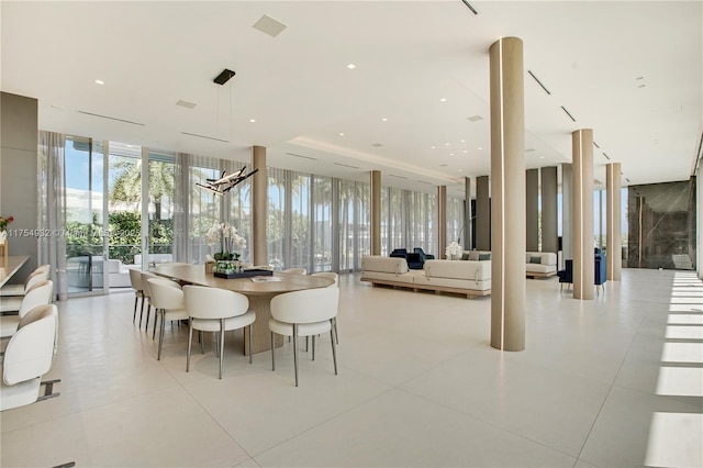 dining space featuring a wall of windows and light tile patterned floors