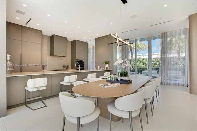 dining area featuring recessed lighting, a wall of windows, and light tile patterned flooring