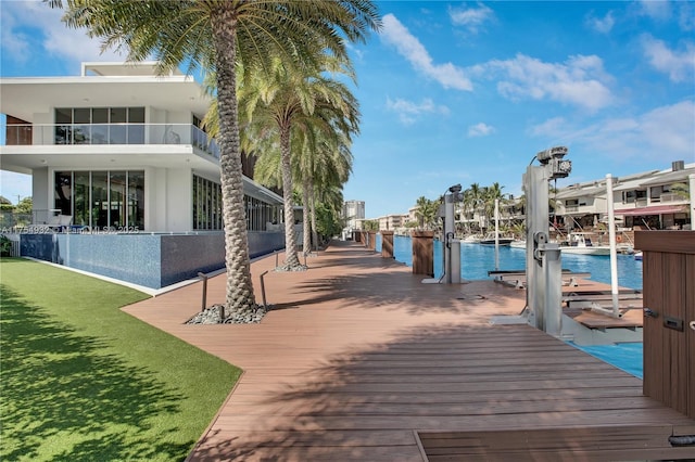 dock area with a water view and boat lift