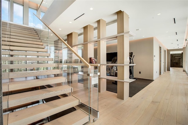 stairs featuring hardwood / wood-style flooring and recessed lighting