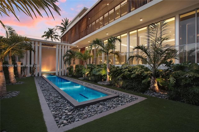view of pool at dusk