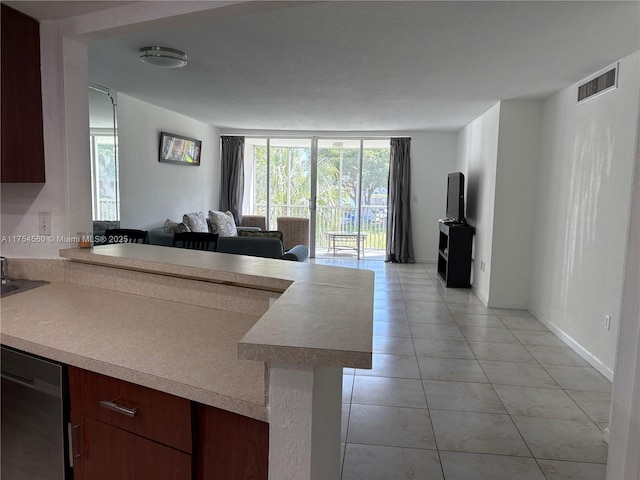 kitchen with visible vents, dishwasher, open floor plan, a peninsula, and light countertops