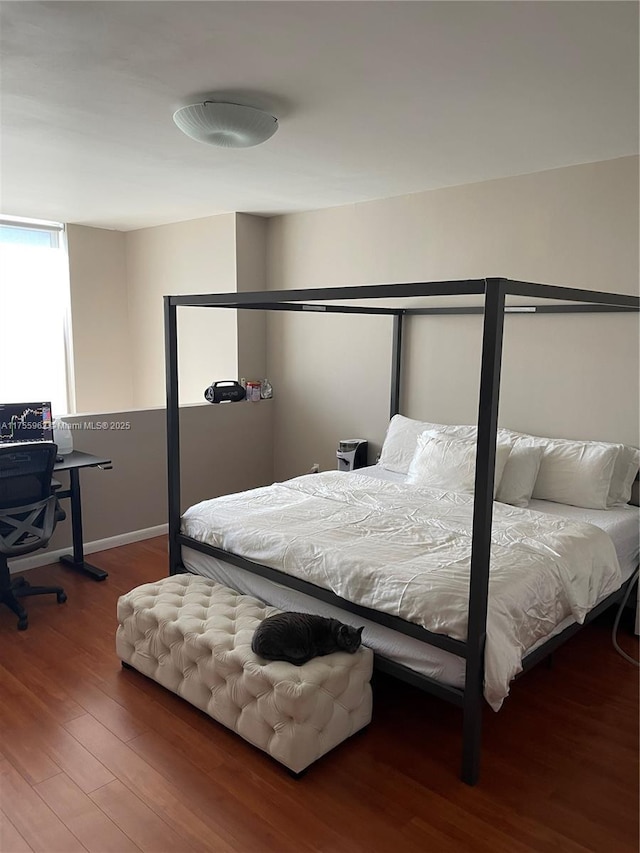 bedroom with wood finished floors