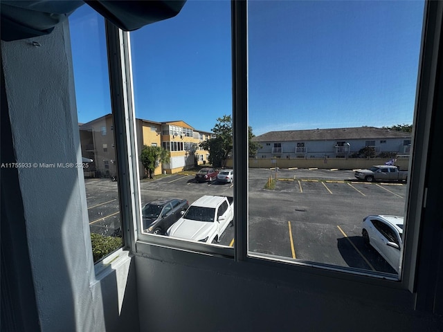 uncovered parking lot with a residential view