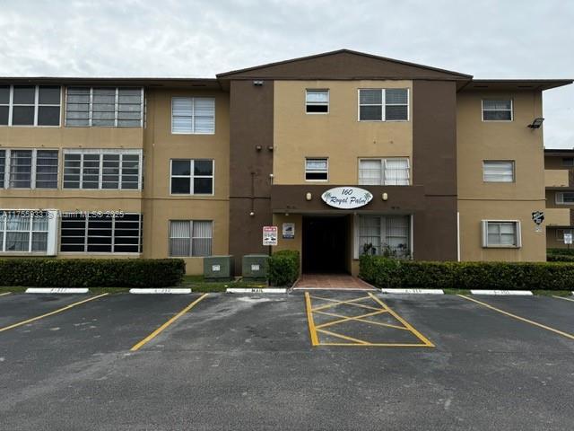 view of building exterior with uncovered parking