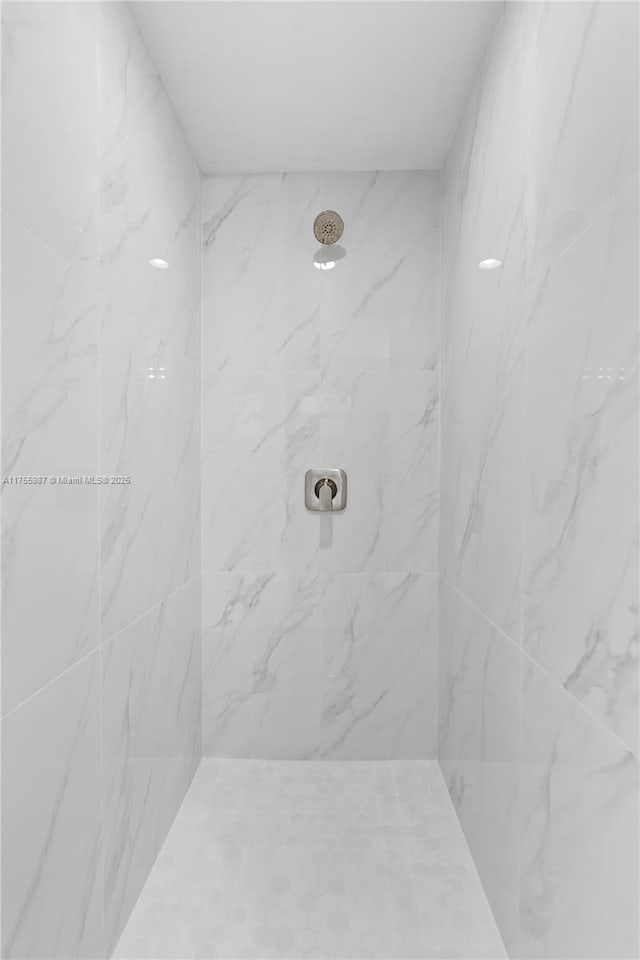 full bathroom with a marble finish shower