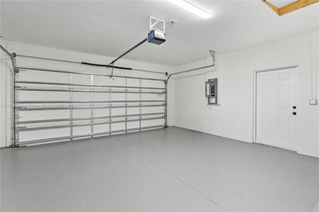 garage with electric panel and a garage door opener