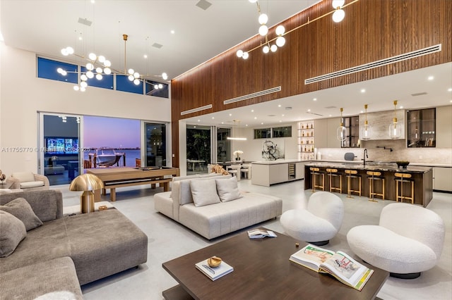 living room with a high ceiling and a notable chandelier