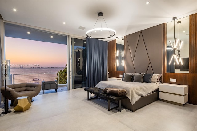bedroom featuring a wall of windows and access to exterior
