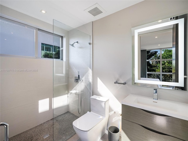 full bathroom with walk in shower, toilet, visible vents, and vanity