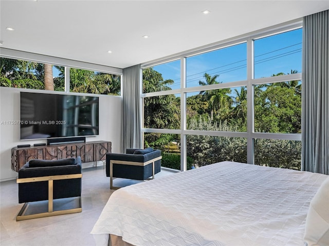 bedroom with floor to ceiling windows and recessed lighting