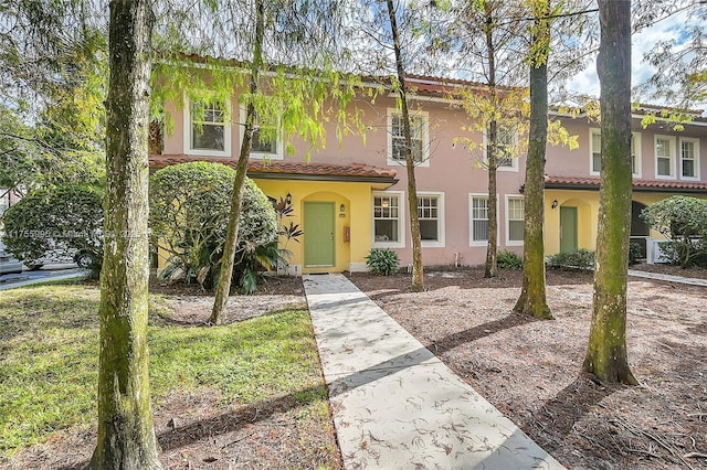 view of front of property with a tiled roof and stucco siding