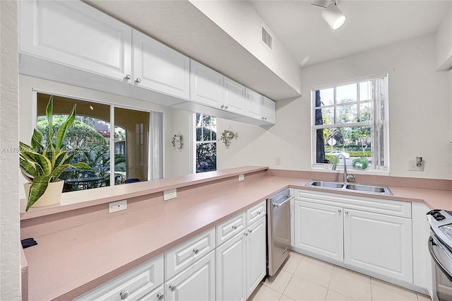 kitchen with stainless steel appliances, light countertops, visible vents, white cabinets, and a sink