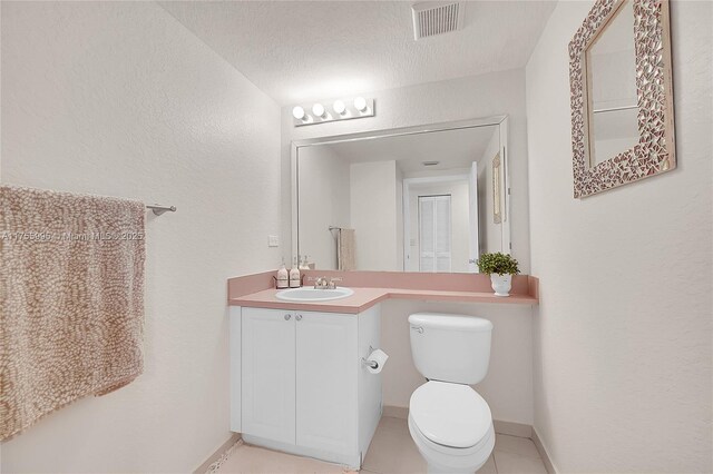 bathroom featuring baseboards, visible vents, vanity, and toilet