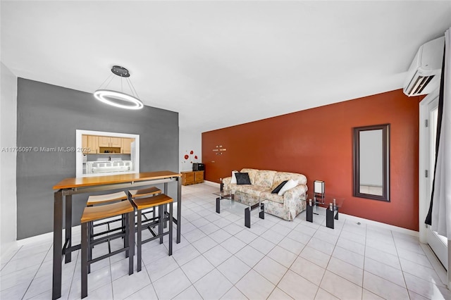 interior space featuring light tile patterned floors, an accent wall, a wall mounted AC, and baseboards