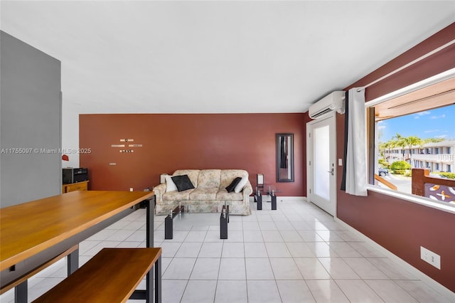 living area featuring baseboards, light tile patterned flooring, and a wall mounted air conditioner