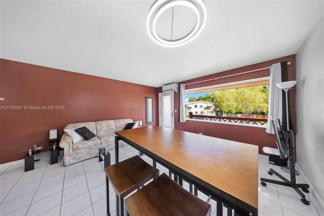 dining space with baseboards, an AC wall unit, and light tile patterned flooring