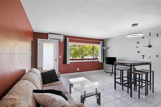 living room featuring a wall mounted air conditioner, baseboards, and light tile patterned floors