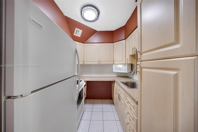 kitchen with light tile patterned floors, light countertops, visible vents, a sink, and white appliances