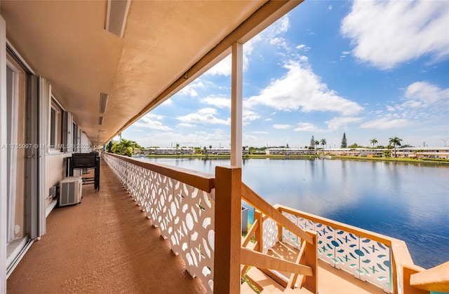 balcony featuring a water view and visible vents