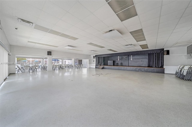 miscellaneous room featuring speckled floor, a paneled ceiling, and visible vents