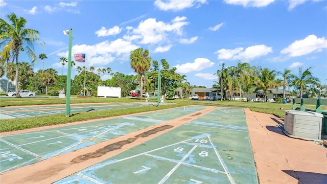 surrounding community featuring shuffleboard and a lawn