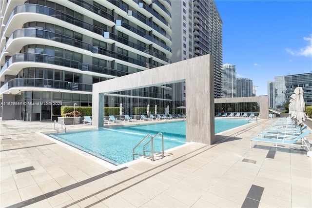 community pool featuring a patio area and a city view