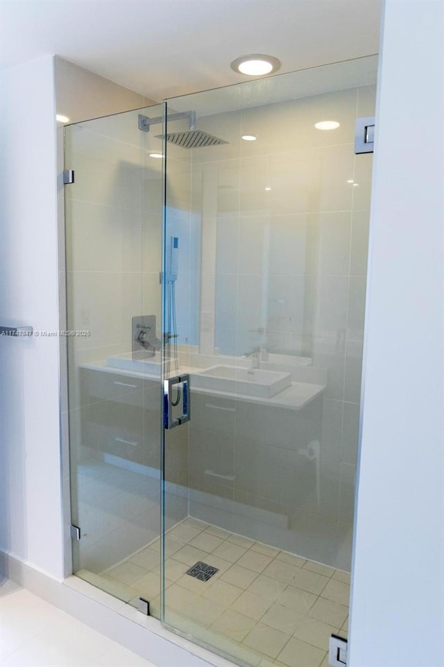 full bathroom with a stall shower and a sink