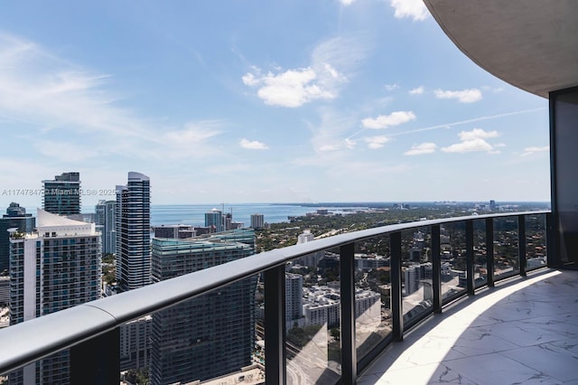 balcony with a view of city and a water view