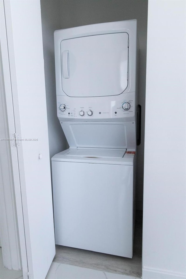 laundry room featuring laundry area and stacked washer / dryer