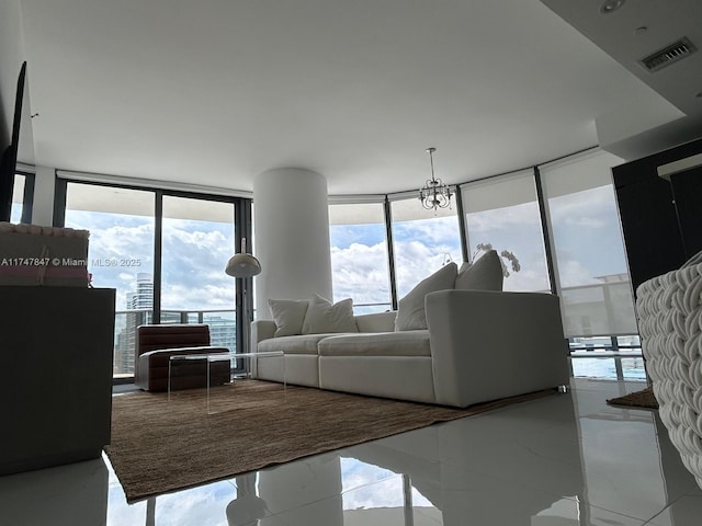 living room with marble finish floor, visible vents, and a wall of windows