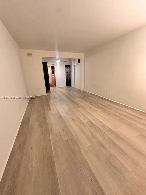 spare room with light wood finished floors and baseboards