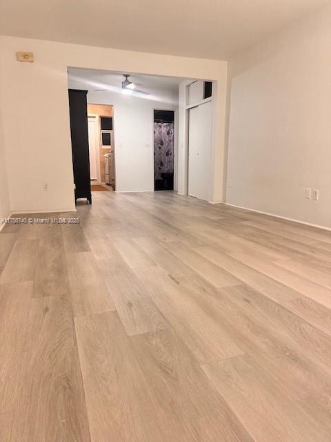 empty room with baseboards and light wood finished floors