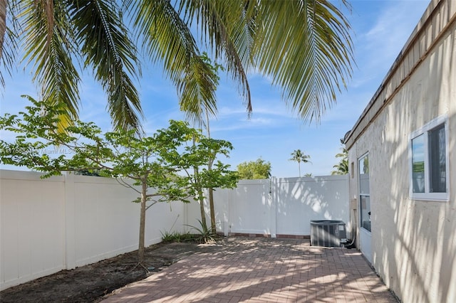 view of patio / terrace with a fenced backyard and central AC unit