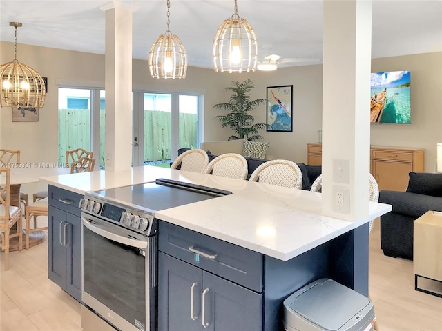 kitchen with pendant lighting, light wood finished floors, gray cabinets, electric range, and open floor plan