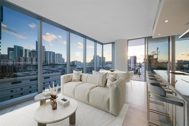 living room featuring recessed lighting, floor to ceiling windows, and a view of city