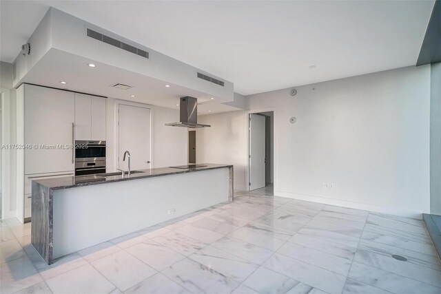 700 NE 26th Ter Unit 1105, Miami, FL 33137 - kitchen with island exhaust hood, a sink, black electric cooktop, stainless steel double oven, and light marble finish floors