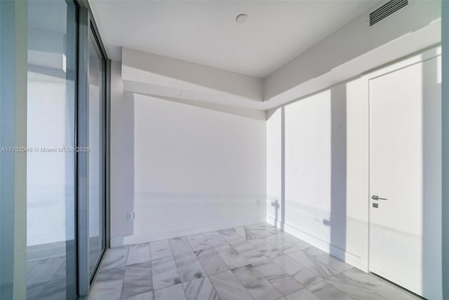 interior space featuring visible vents, baseboards, and marble finish floor