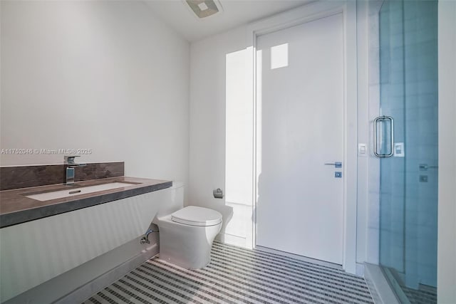 bathroom featuring toilet, a stall shower, and vanity