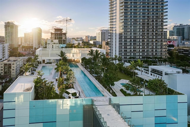 pool at dusk with a city view