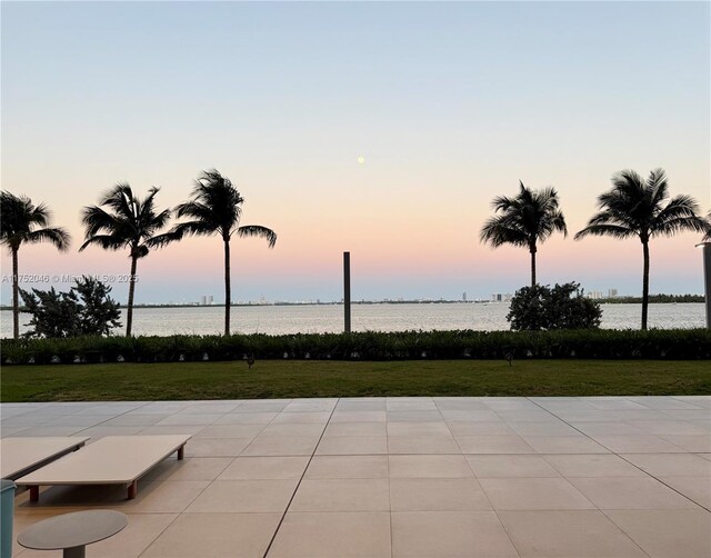 700 NE 26th Ter Unit 1105, Miami, FL 33137 - patio terrace at dusk featuring a yard, a water view, and a patio area