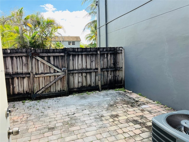 exterior space featuring fence, a gate, and central air condition unit