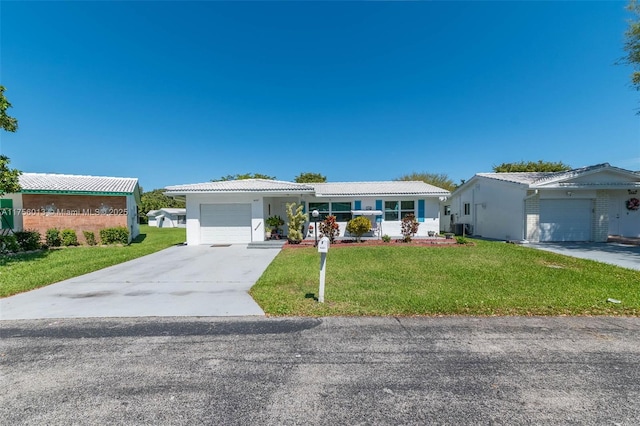 single story home with an attached garage, driveway, a front yard, and a tiled roof