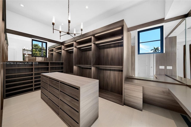 spacious closet featuring a notable chandelier