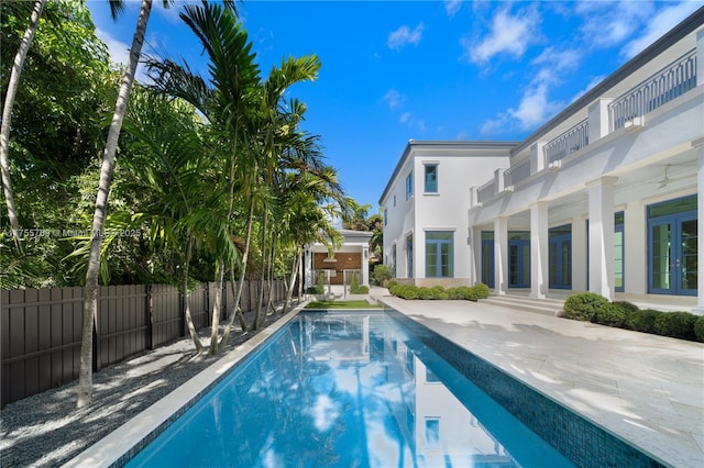 view of swimming pool with a patio, fence, a fenced in pool, and french doors