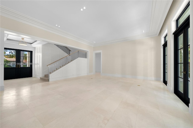 empty room featuring baseboards, stairway, crown molding, and french doors